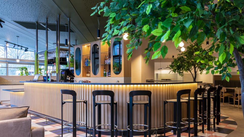Inside Manor Park Social, showing the bar area with high chairs