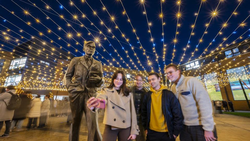 Students taking a selfie under the blanket of lights