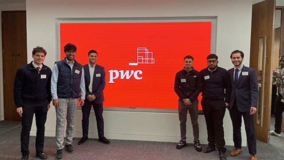 PwC event with people by sign