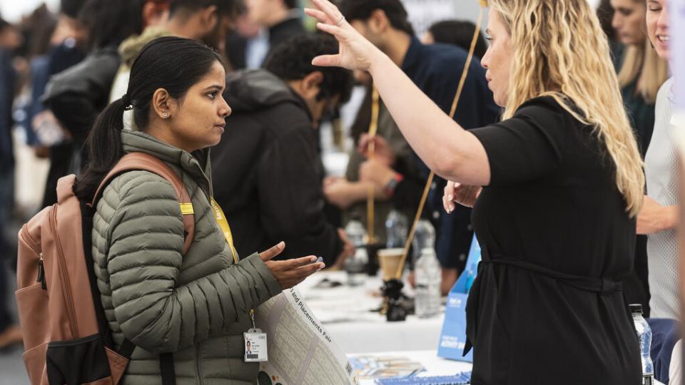 A student talking to an employer at c careers fair