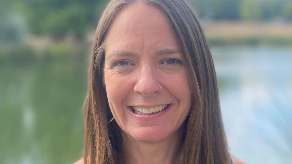 Picture of Clare smiling in front of the lake