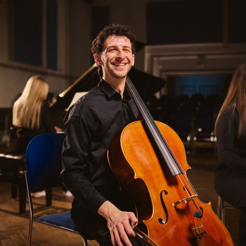 Student holding cello